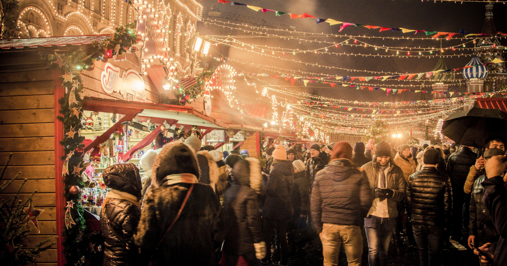 A group of people standing at a Christmas market