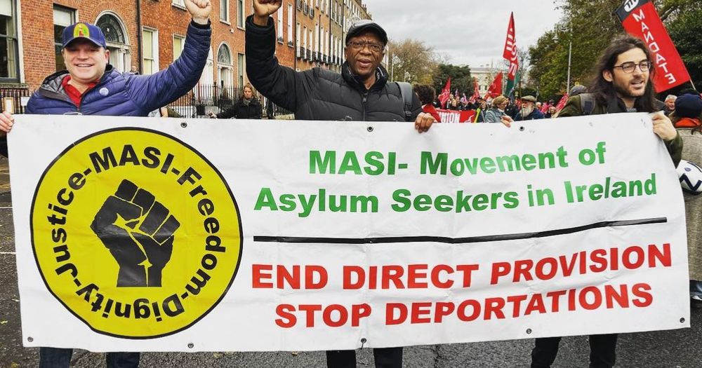 Three men holding a MASI sign to represent Lucky Khambule statement on anti-refugee movements "escalating" in Ireland