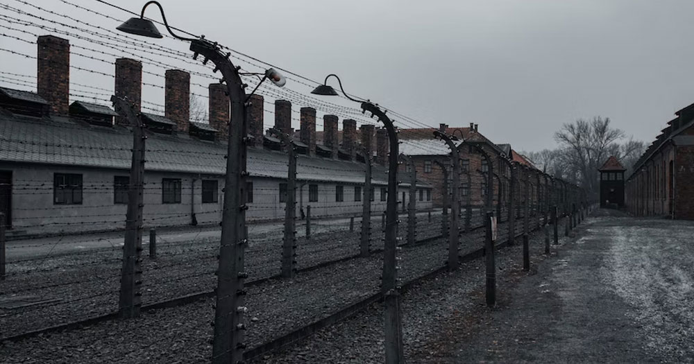 This article is about a commemoration for the LGBTQ+ victims of the Holocaust. In the photo, a concentration camp of the Nazi regime.