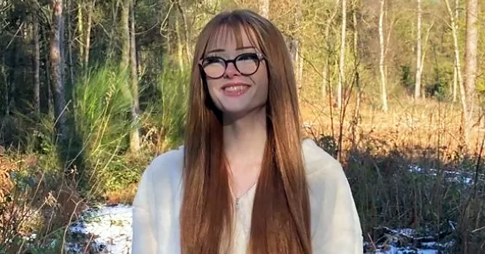 Photo of Brianna Ghey, whose murder is baing investigated and two suspects have been charged, smiling while sitting at a table in a wood.