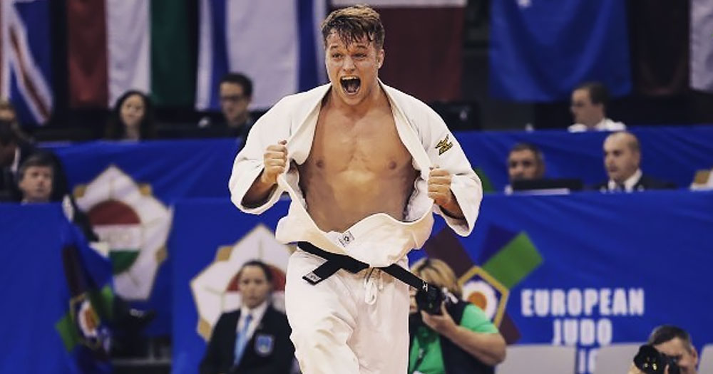Openly gay judo fighter Timo Cavelius cheering after having won a fight against an opponent.