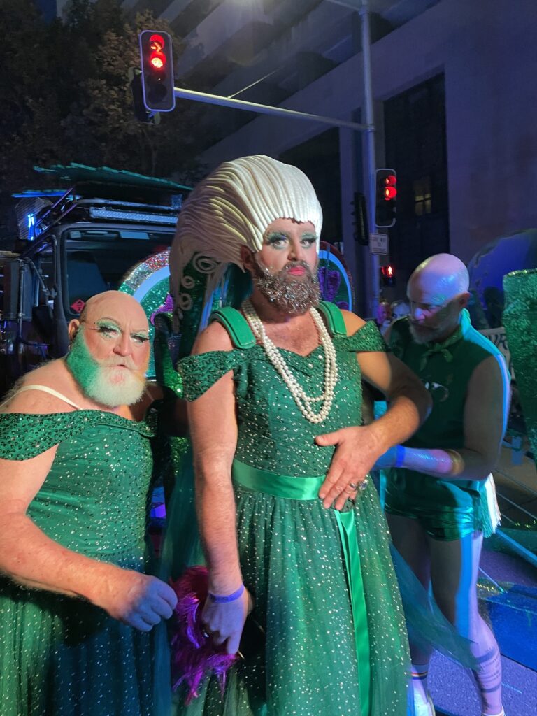 Two members of Sydney Queer Irish dressed in elaborate green costumes.