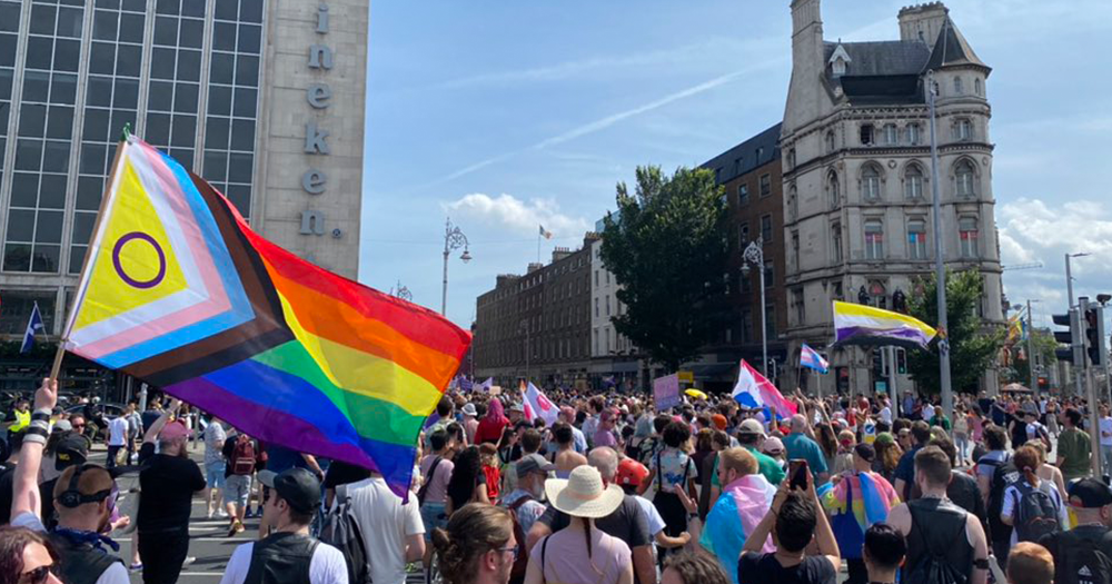 Crowd of people in Dublin with Pride flags representing support for conversion therapy ban in Ireland.