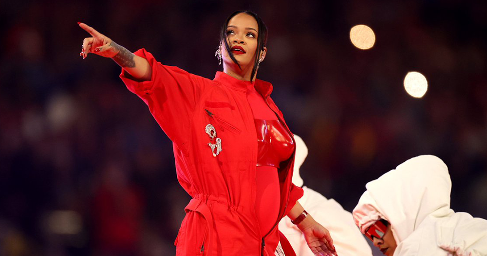Rihanna wears a red costume while performing at the 2023 Super Bowl halftime show.
