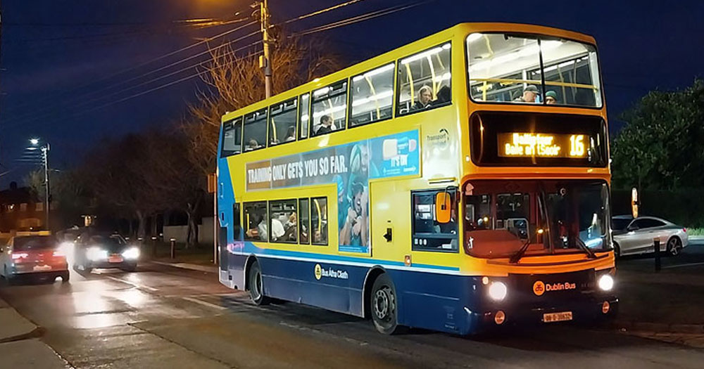 This article is about a teen charged over a homophobic attack. In the photo, a Dublin bus, where the attack took place, on the streets of Dublin at night.