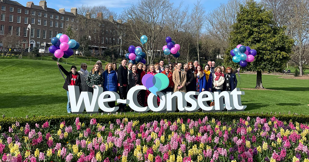 Photo from the launch of the We-Consent campaign, with team members pictured in a garden with balloons and banners.