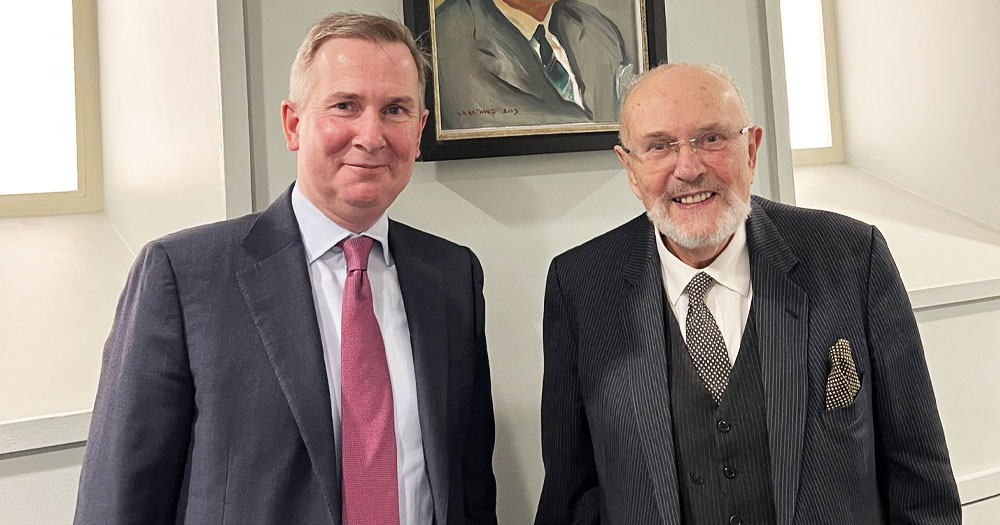 Senator David Norris and Justice David Barniville standing in front of a portrait.
