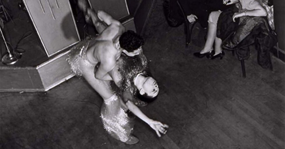 This article is about the history of drag balls in Harlem, New York City in the early 20th century. The image shows two performers dancing at one of these famous events.
