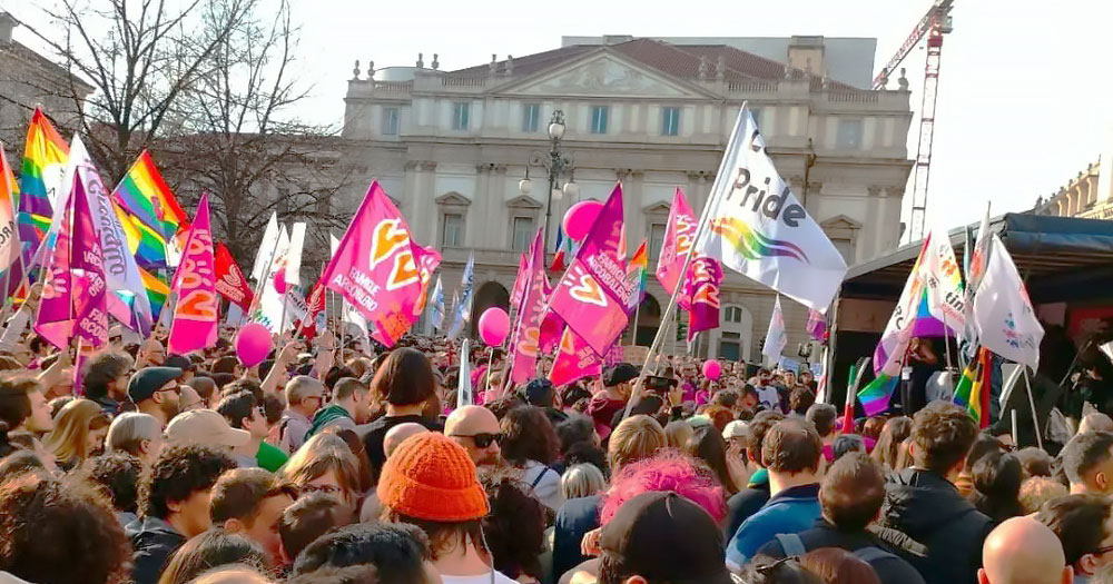 Protest in Italy for the rights of same-sex parents. People are waving Pride and purple in solidarity with association Rainbow Families.