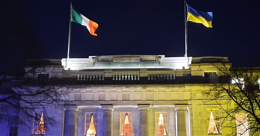 Ukraine flag and Ireland flag are perched on building, the article is about a LGBTQ+ couple who moved to Ireland last year.
