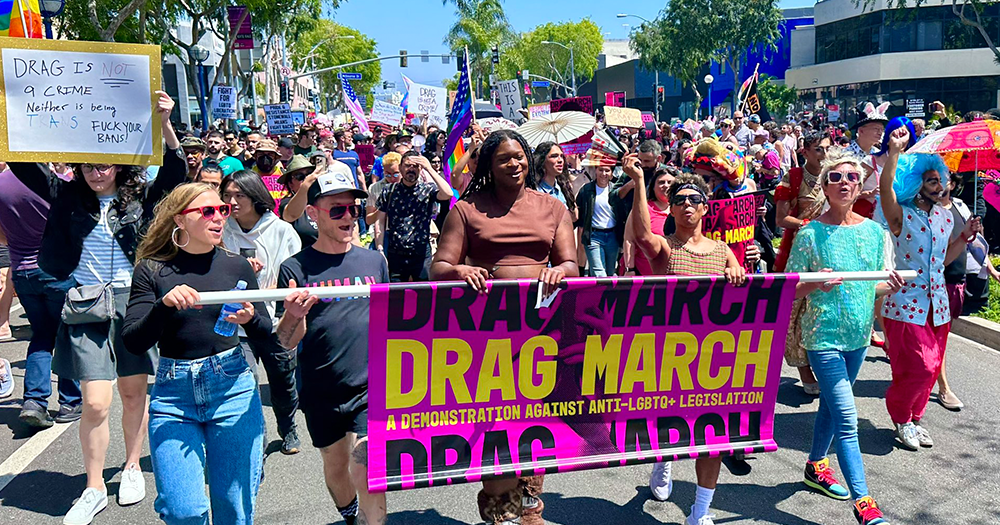 A group of protestors march with Drag March sign, on Easter Sunday in Los Angeles, California, thousands of people showed their support for LGBTQ+ people by attending Drag March LA.