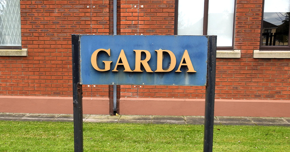 A blue and yellow Gardaí sign.