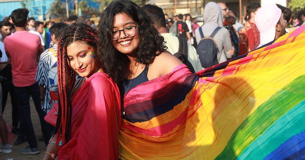 Two women pose with Pride flag in India where the country is debating same-sex marriage