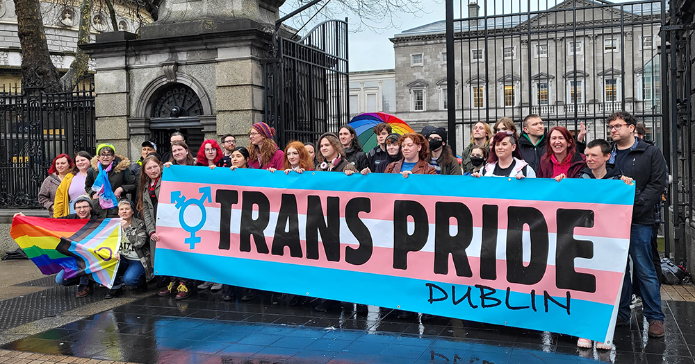 Crowd with Trans Pride banner and Pride flags gathered on Transgender Day of Visibility to share their struggles, advocate for their rights, and fight back against oppression. 
