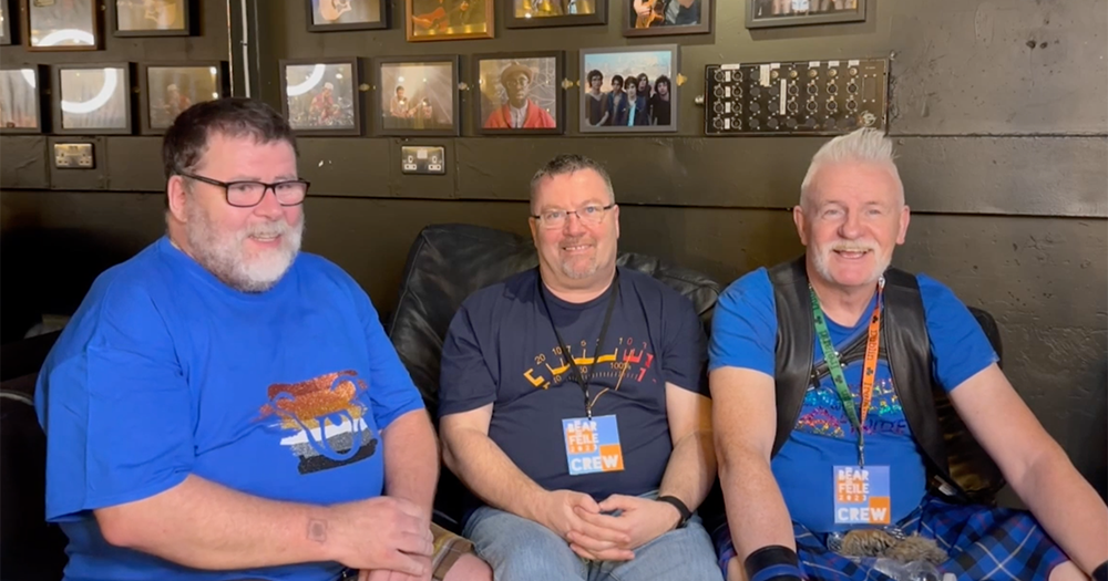 Three members of Dublin Bears sitting on a couch smiling.