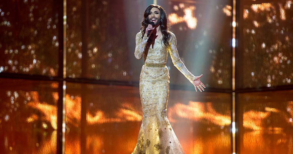 Drag queen performs in gold gown in LGBTQ+ Eurovision milestone.
