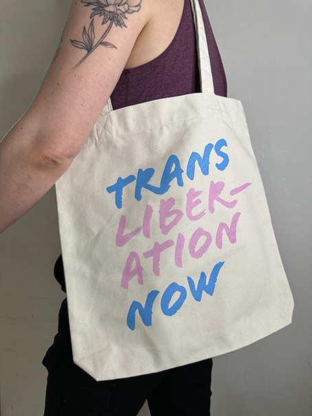 "Trans Liberation Now" tote bag from queer GCN merch collection.