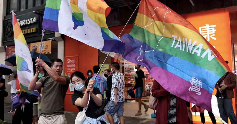 Activists in Taiwan, where same-sex couples have been granted adoption rights, waving Pride flags with Taiwan written on it.