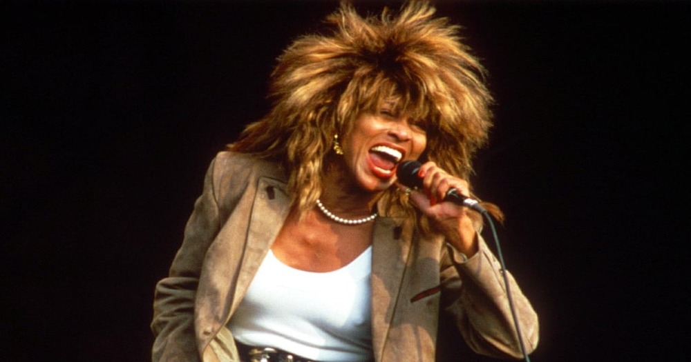 Head-on view of Tina Turner singing into a microphone