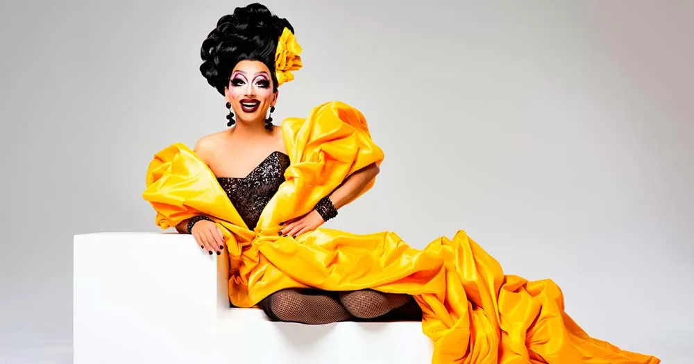Drag queen Bianca Del Rio wearing a bright yellow gown.