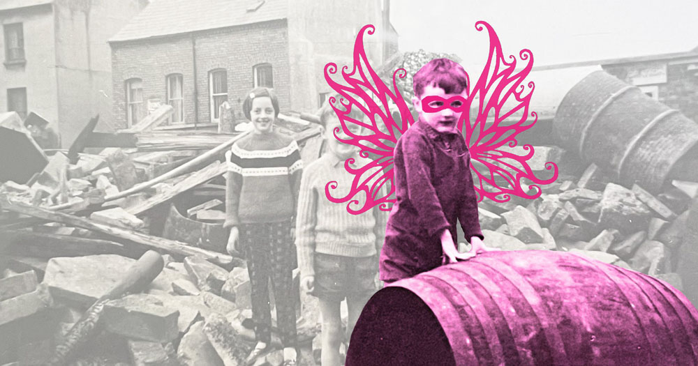 The image is a promotional graphic for the show Border Fairies. It shows a faded black and white photo of children playing amongst rubble. In the foreground is a young boy. He has been coloured in a pink tone and fairy wings and an eye mask have been drawn over him.