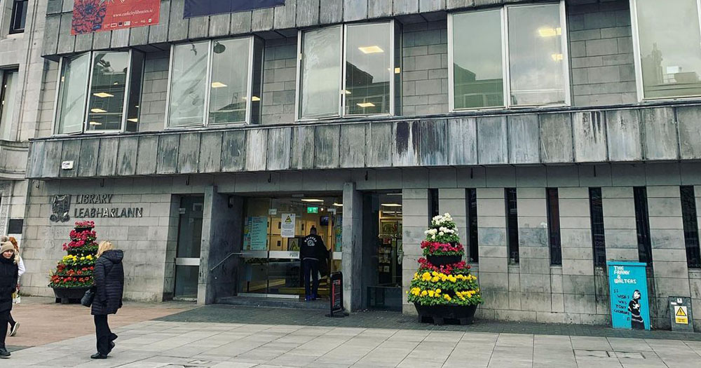 Cork City Council are being threatened with industrial action over failure to provide support for staff. The image shows a image of the front of Cork Central Library. It is a modern grey concrete building.