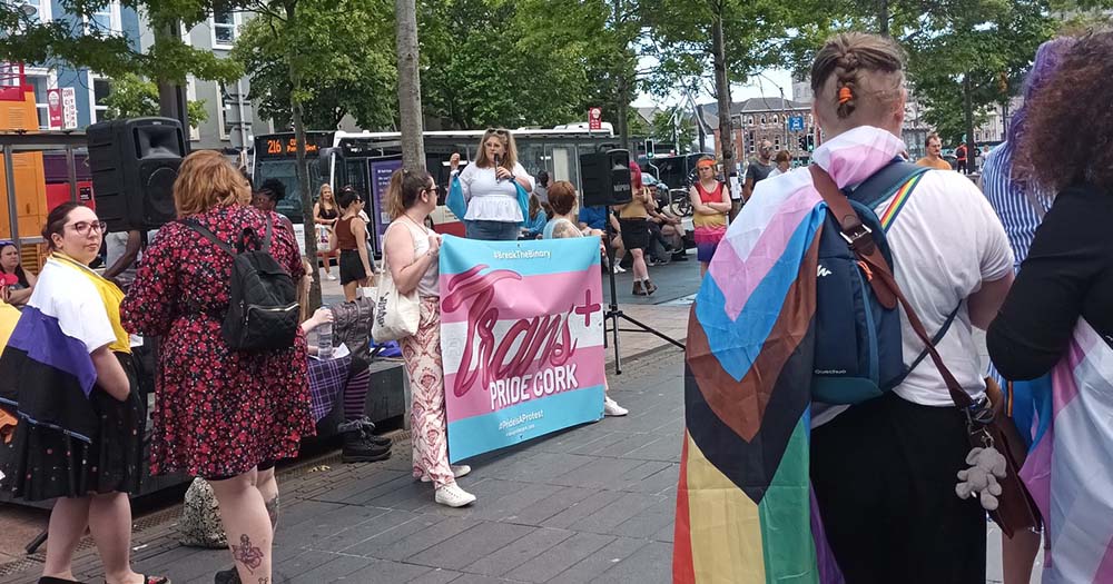 Group of people wearing Pride flags gathers in Cork for Trans Pride.