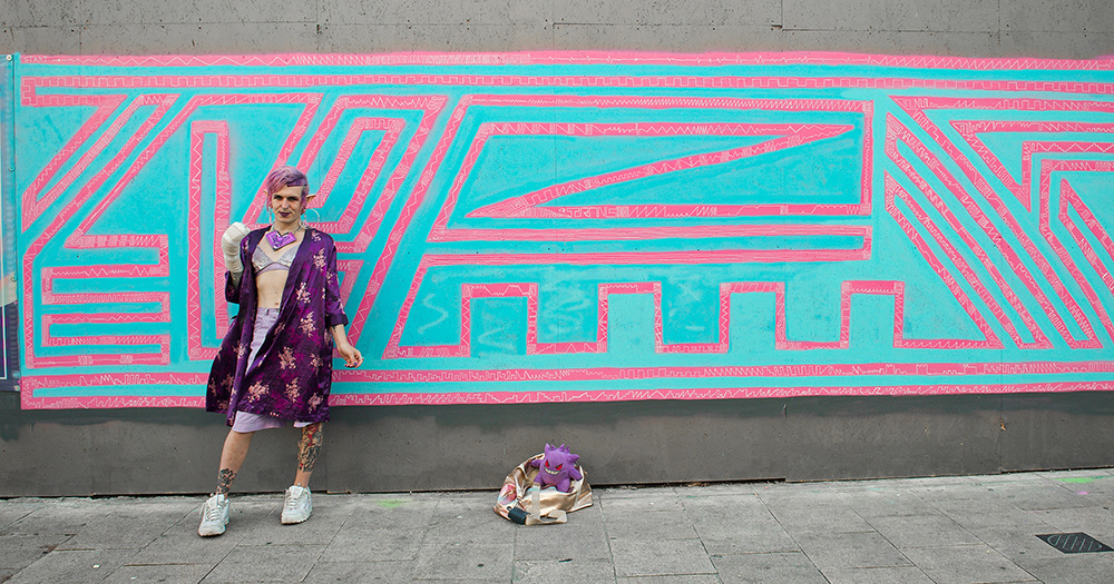 Saturn WölfflöW in front of her Trans mural.