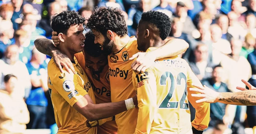 Four players from Wolves football club celebrating a goal.