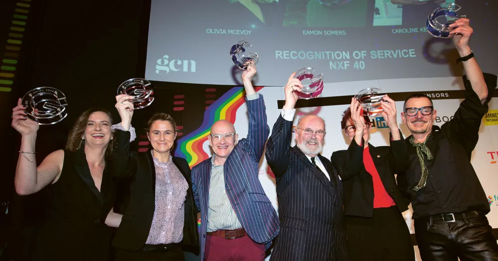 Nominations for the 2023 GALAS close soon. The photo shows the winners of the NXF 40 award from the GALAS 2020. Six people are standing on a stage holding glass trophies in the air. The trophies are in the shape of a 'G'. There are three men and three women.