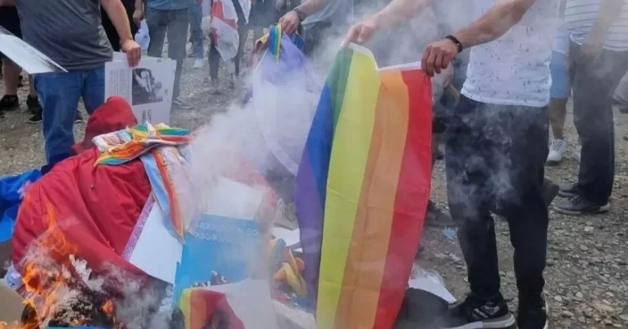 Anti-LGBTQ+ protestors burning Pride flags after storming Tbilisi Pride in Georgia.