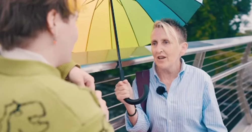 Nuala Ward holds rainbow umbrella while being interviewed for a SpunOut video series.