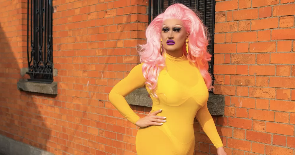Drag artist Victoria Secret, who spoke about the far-right in the article, wearing a yellow dress and pink wig.
