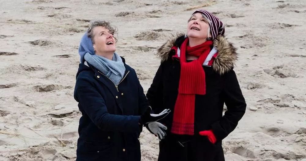 Zrazy have released a new World Cup anthem. The image shows Carole Nelson and Maria Walsh on a beach bouncing a football over their heads.