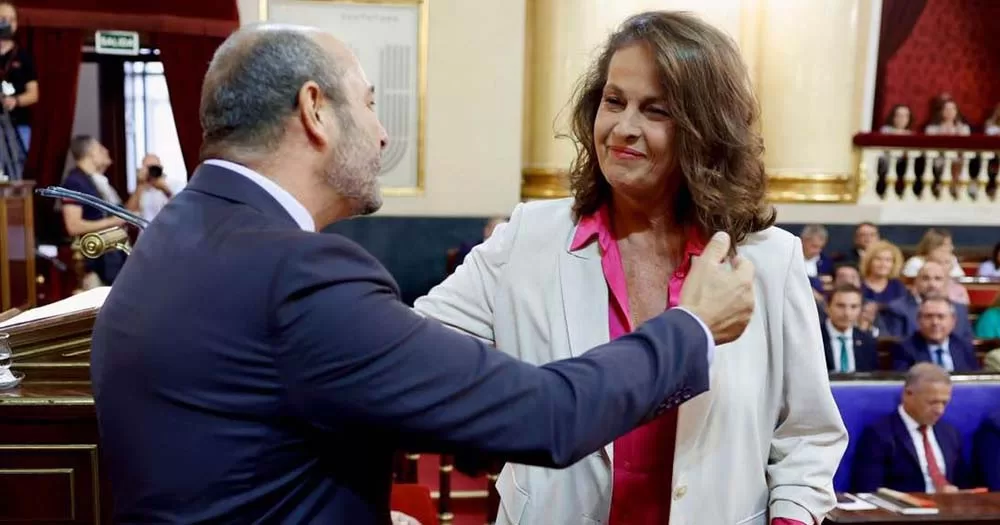 Spain's newly elected openly trans senator, Antonelli, reaches out toward fellow lawmaker after being elected.