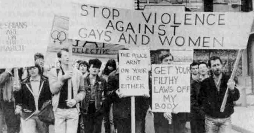 This article is about the AIDS crisis being used against decriminalisation. In the photo, a protest in Dublin with people carrying protest signs.