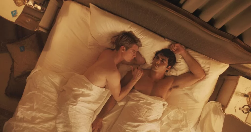 Screenshot of movie Red, White and Royal Blue showing the two protagonists laying in bed.