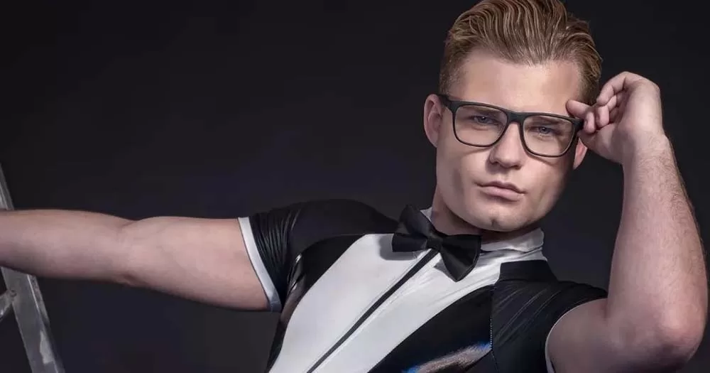 mr gay Ireland poses in tux bodysuit and glasses