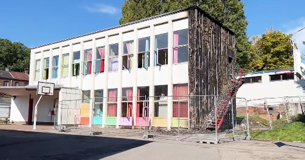 One of the schools targeted in arson attacks in Belgium, with the side of the building completely burned.