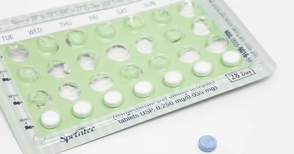 The government has extended the free contraception scheme to include people between 27 to 30. The image shows a package of small white pills marked with days in a green blister pack.