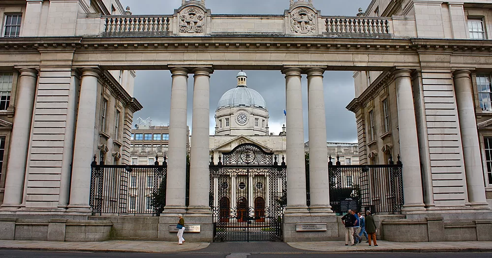 An image of the Dáil where the protest took place. The gate of the building is shown, with another chamber of the building shown in the background.