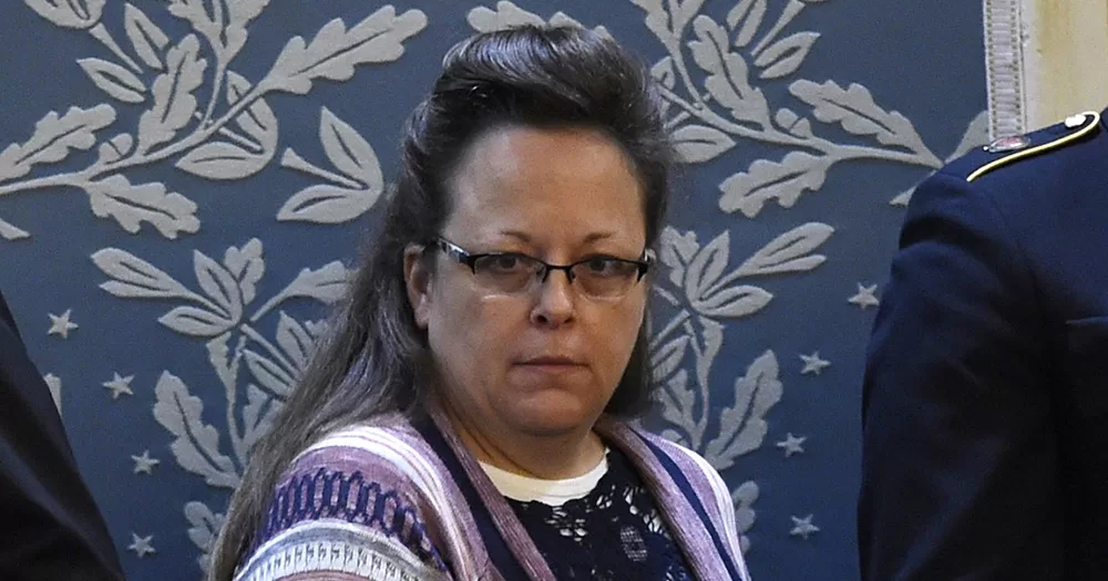 An image of Kim Davis. She looks into the camera, wearing glasses and a patterned cardigan.