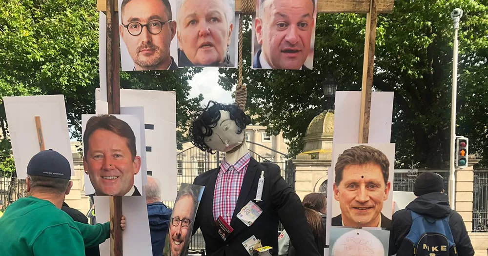 Mock gallows displayed at the Dáil. The wooden structure features a stuffed figure hanging from a noose, as well as photographs of high-profile Irish politicians.