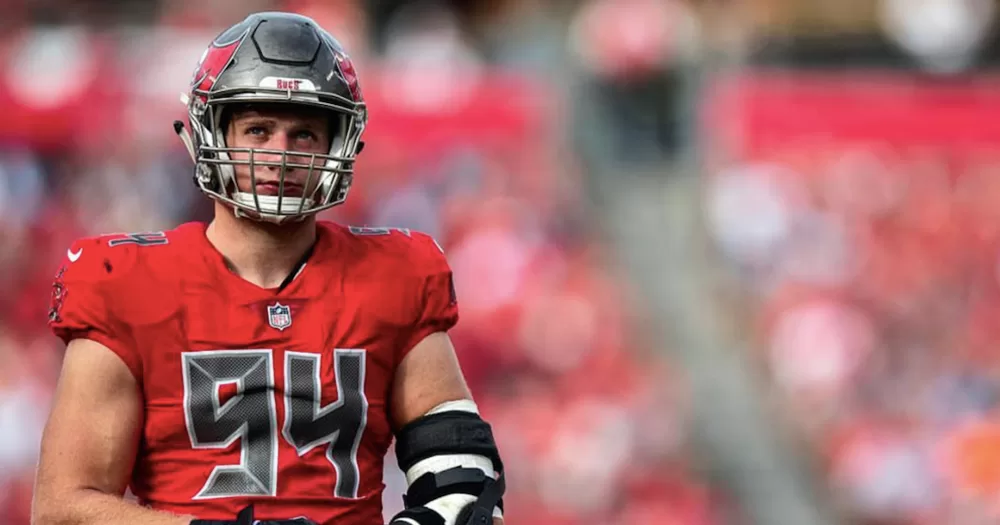 This article is about Carl Nassib announcign his retirement. In the photo, Carl Nassib on the field wearing a red uniform.