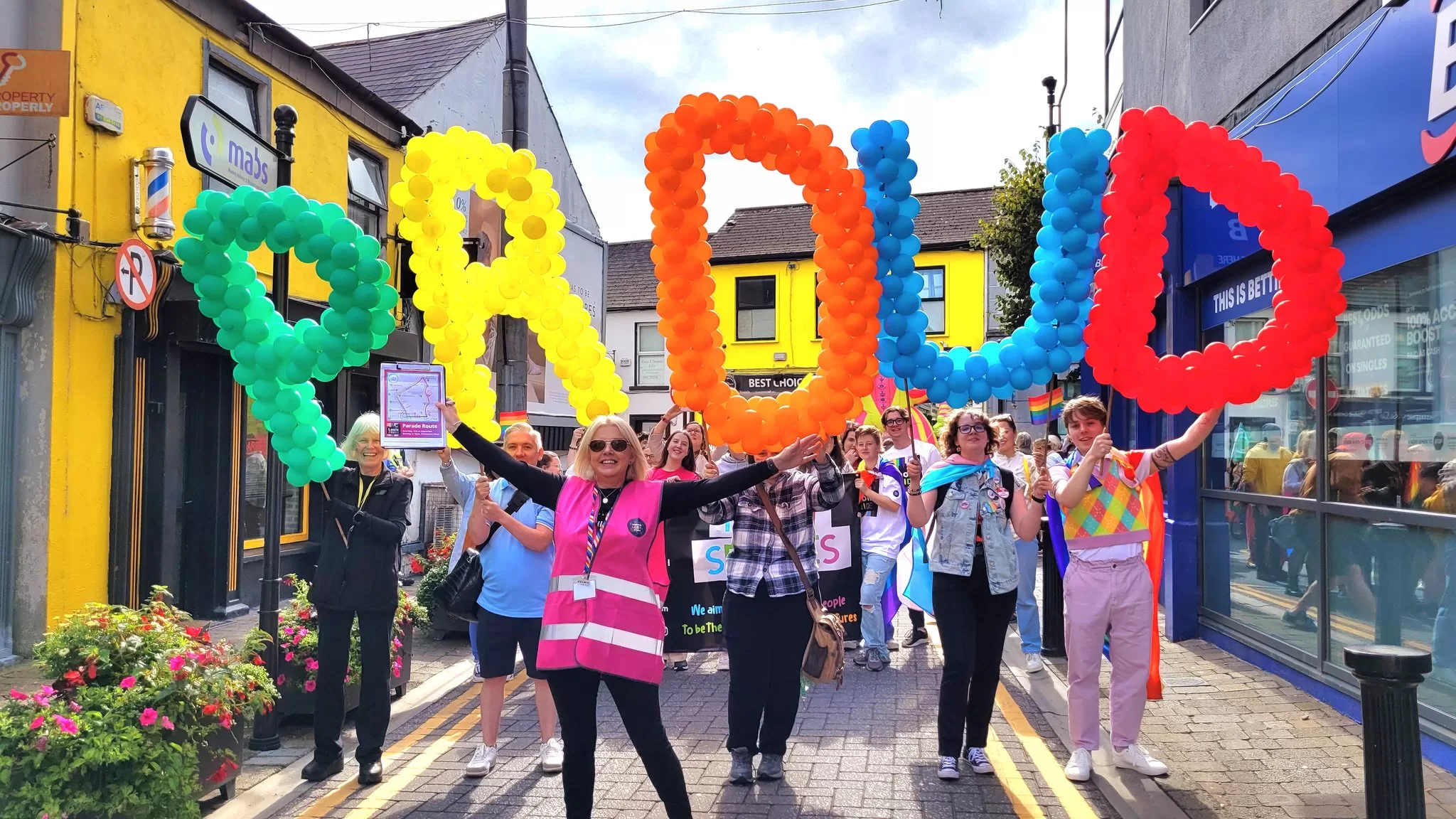 A group of people hold PROUD balloons at the Midlands Laois Pride festival