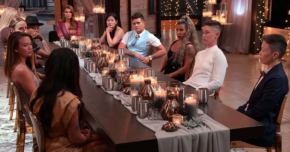 Contestants on Queer Ultimatum sit around dinner table facing each other, casting for season two is now underway.