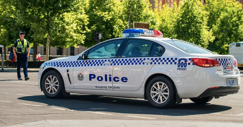 This article is about an Australian homophobic murder. In the photo, a police car and a policeman in Australia.