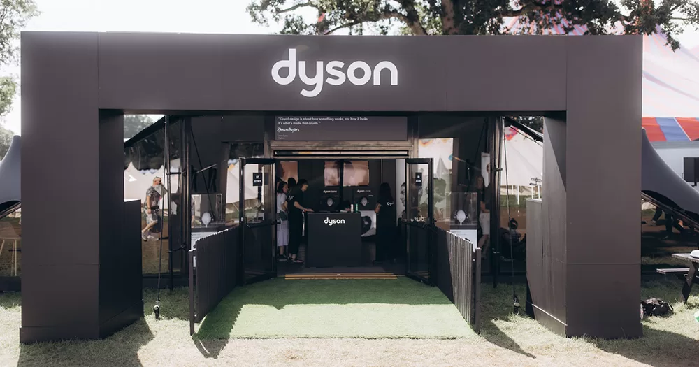 The exterior of the Dyson Zone as Electric Picnic 2023. The image shows a black rectangular arch with the Dyson logo on it, with the styling tent behind it.