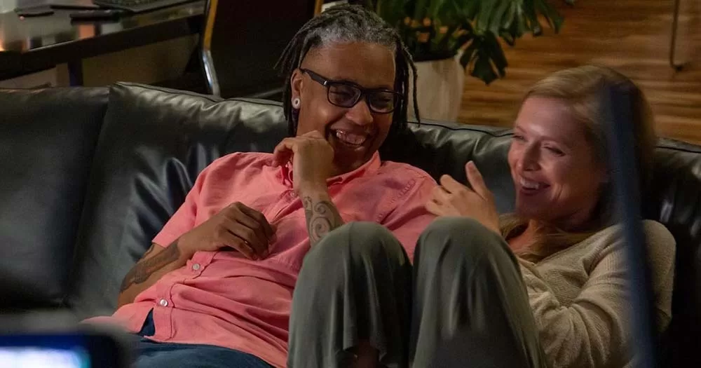 Two people laughing on a couch in an intersex documentary called Every Body.