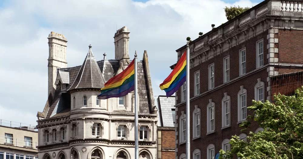 This article is about coming out in Ireland in 1981. In the photo, Pride flags flying in Dublin.
